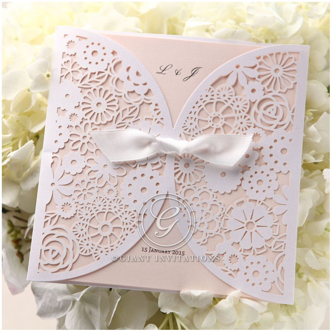 Mesmerizing array of flowers in die cut finish with a dainty bow center draping a light pastel coloured insert card in raised ink
